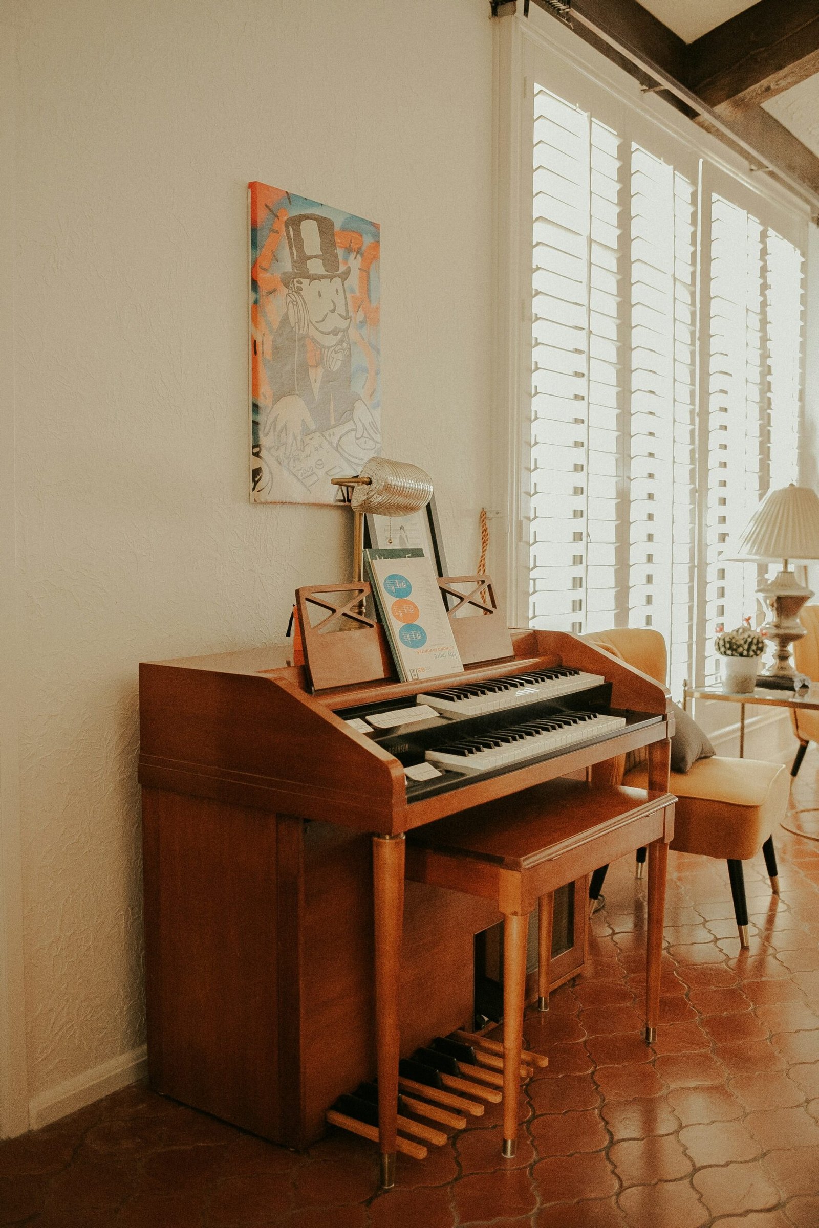A vintage upright piano in a sunlit old apartment