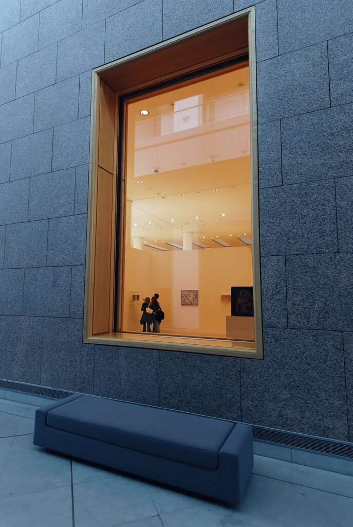 Visitors walking through a white-walled modern art gallery