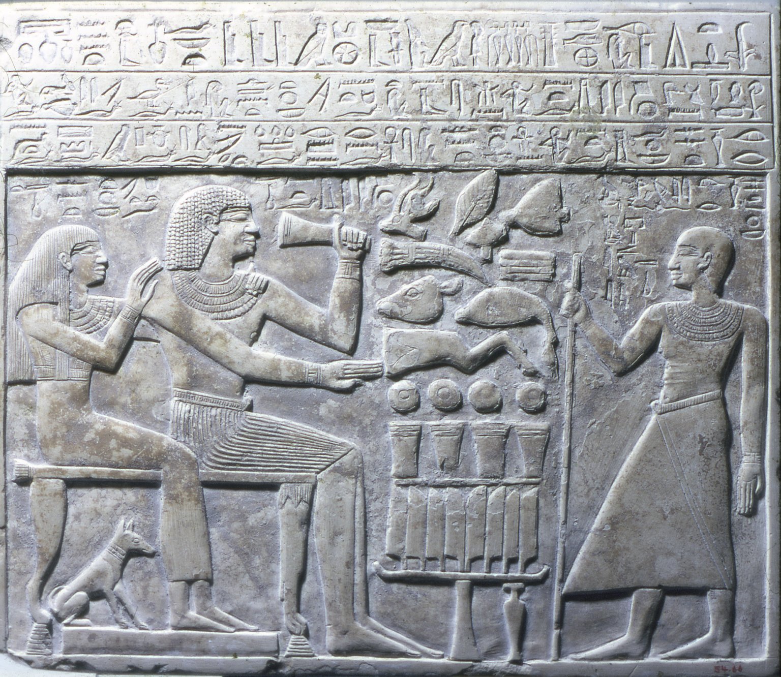 Ancient Egyptian hieroglyphs carved in pale limestone