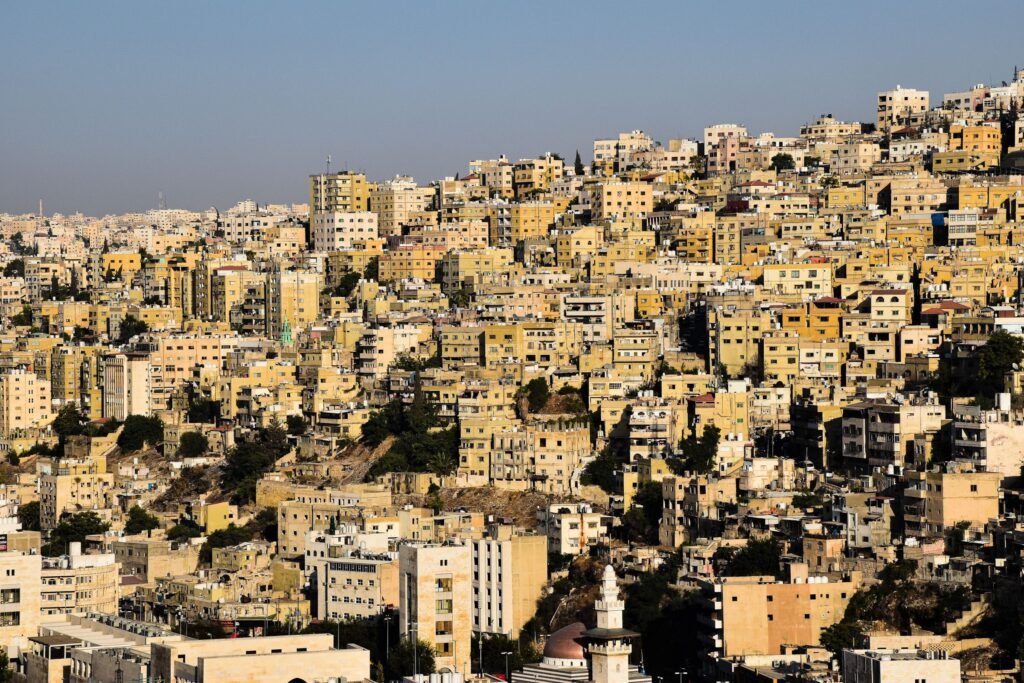 Pale stone houses covering Amman's hills, seen from the Citadel