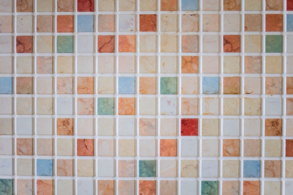 Glazed ceramic tiles in earthy colours laid out side by side
