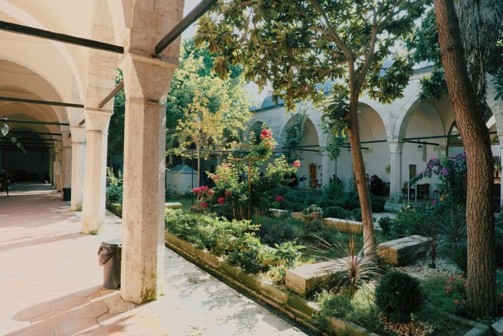 A shaded garden courtyard with a narrow channel of water