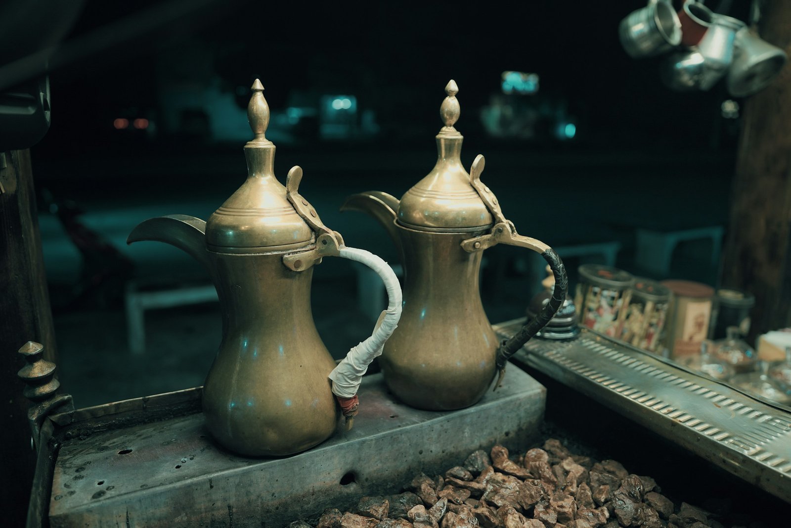 Arabic coffee being poured from a dallah into a small cup