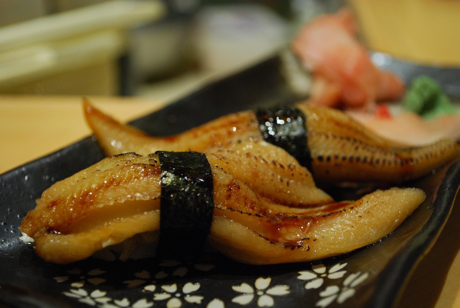 A sushi chef at a wooden omakase counter