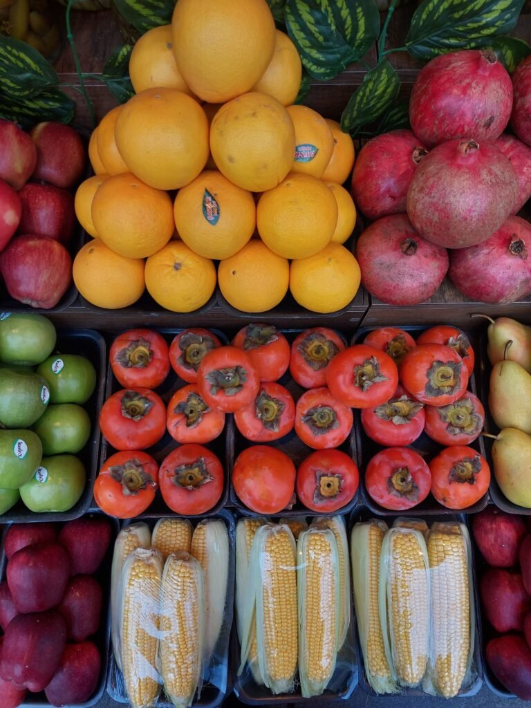 Fresh produce stacked at a farmers market stall