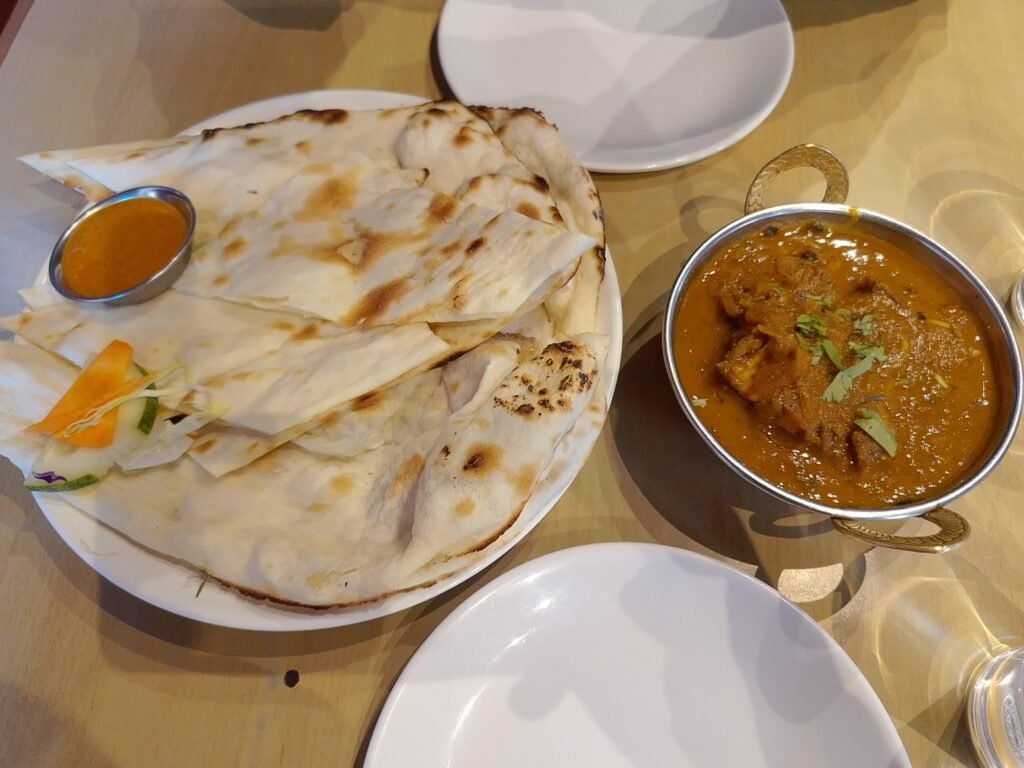A spread of Indian curries with naan