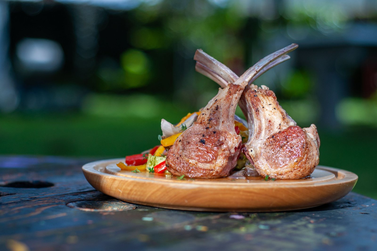 Tandoori lamb chops served on a dark plate