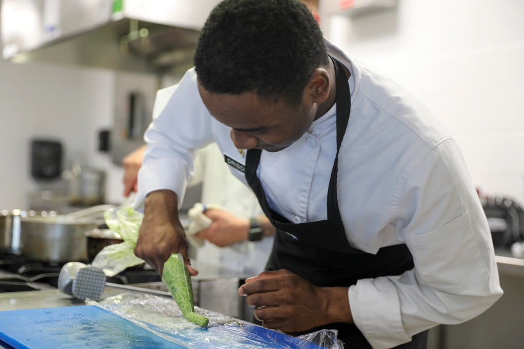 A chef plating a dish at a culinary competition