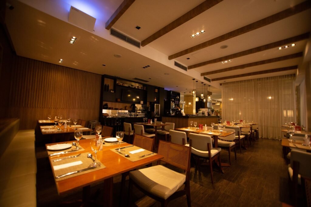 A dining room with white tablecloths set for evening service