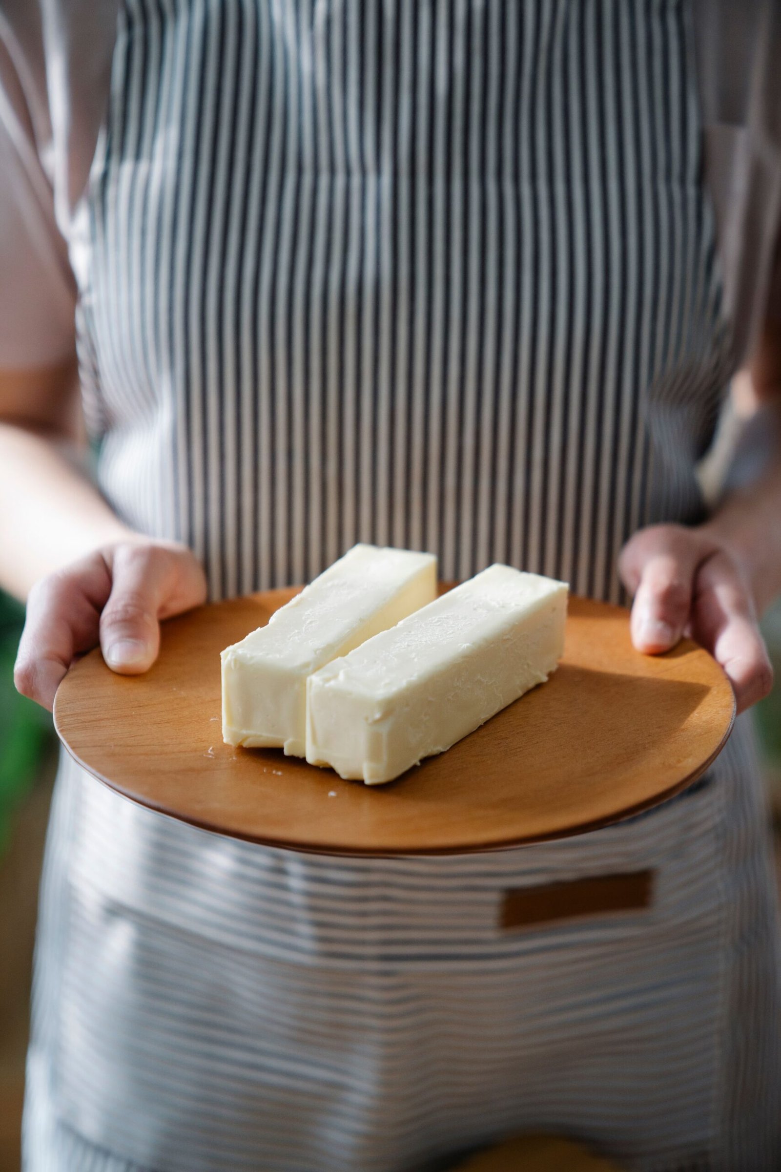 A chef finishing a fine-dining dish with tweezers