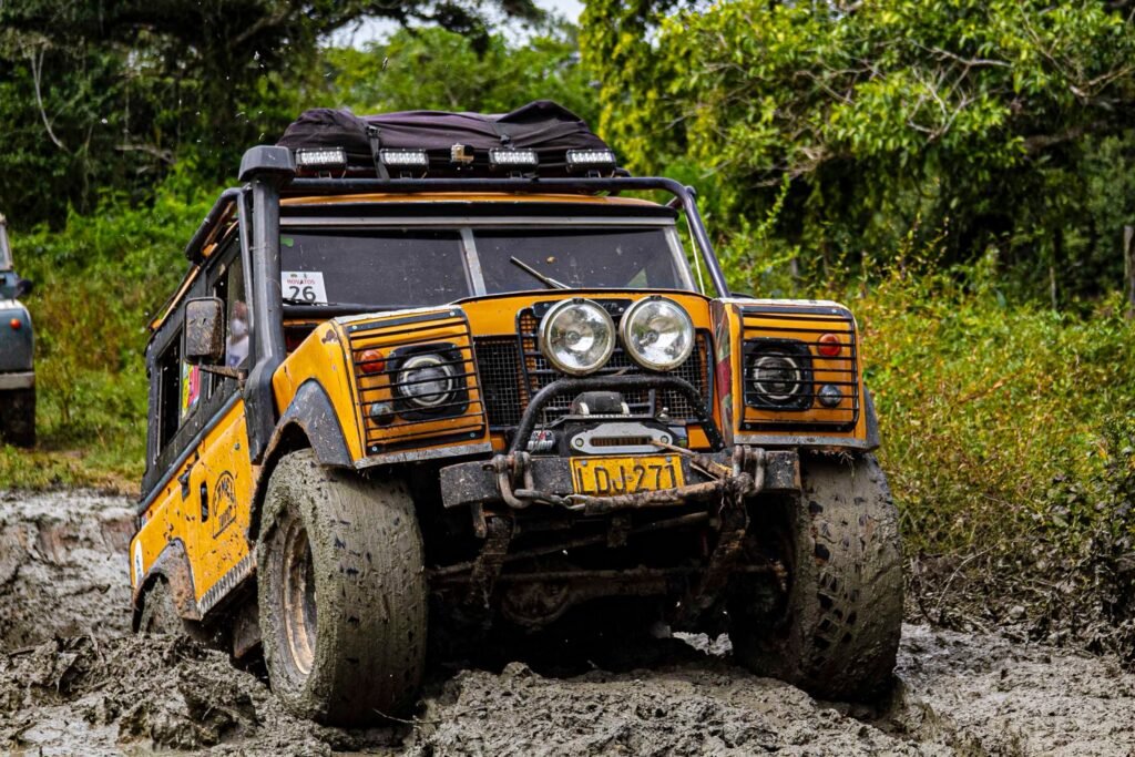 A classic Land Rover parked on a dirt track