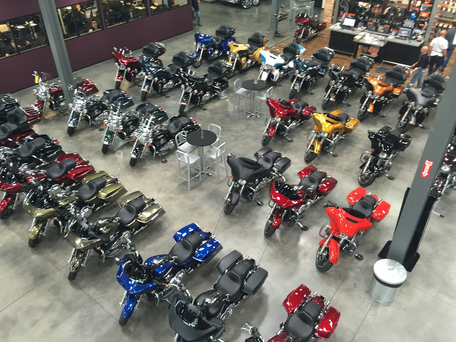 Visitors walking among motorcycles in an exhibition hall