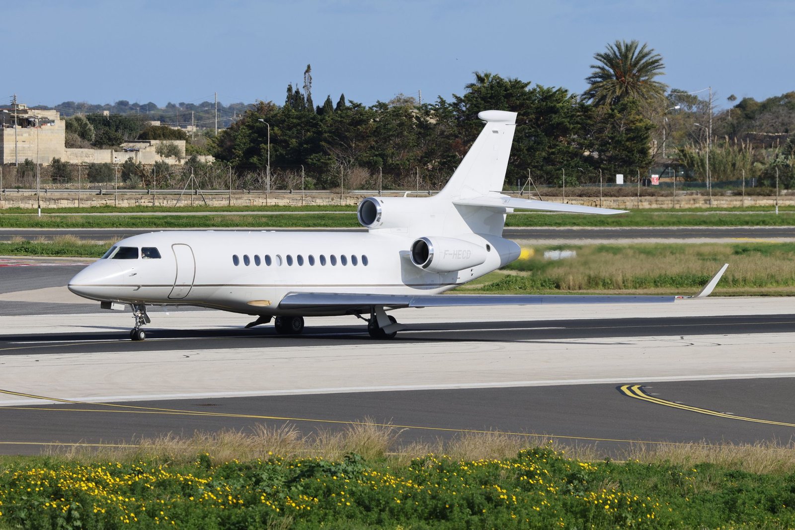 A large business jet on a runway at dusk