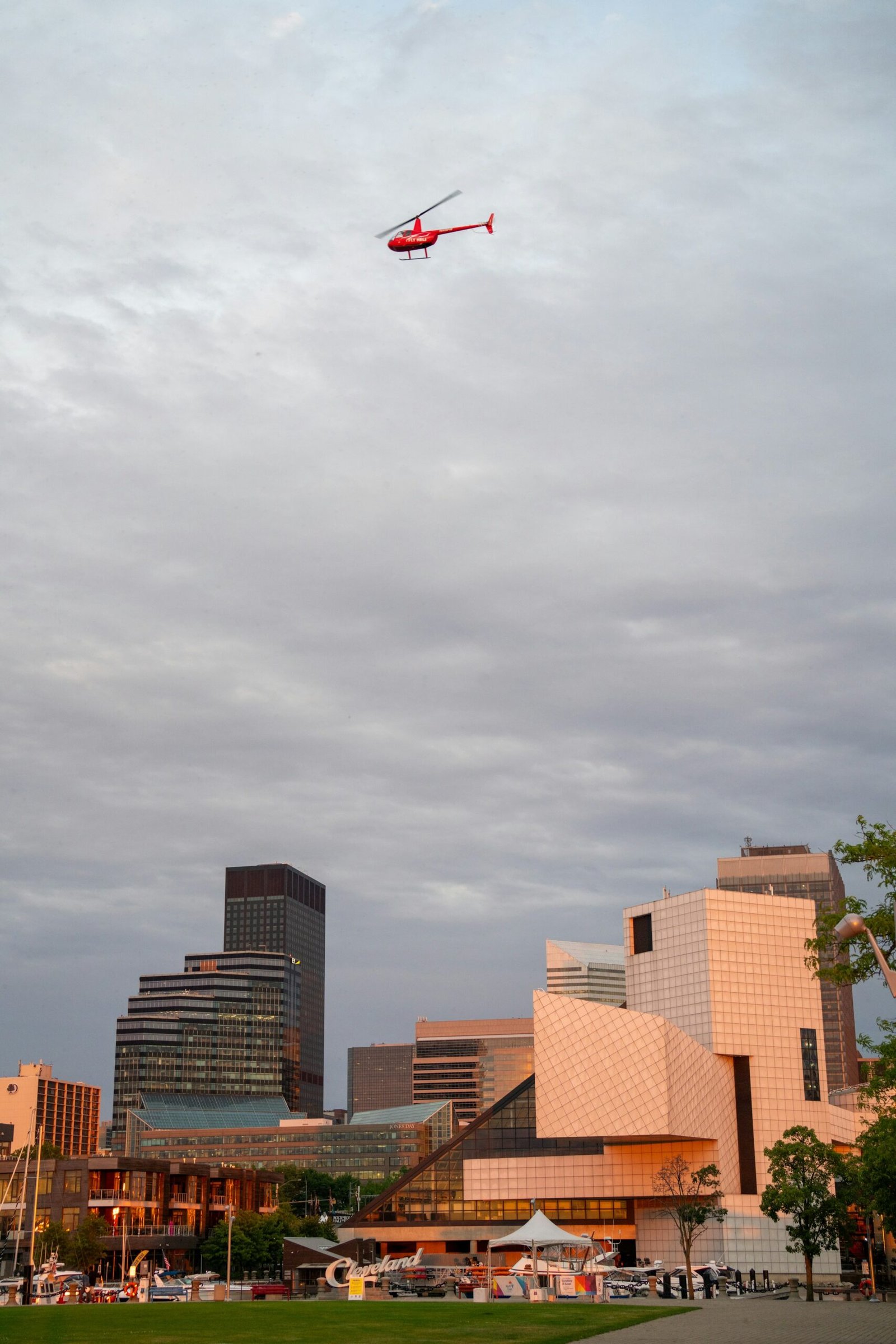 A helicopter flying over a city of tall towers