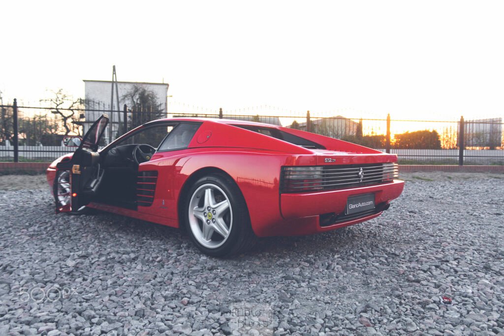 A classic red Ferrari sports car seen from the side