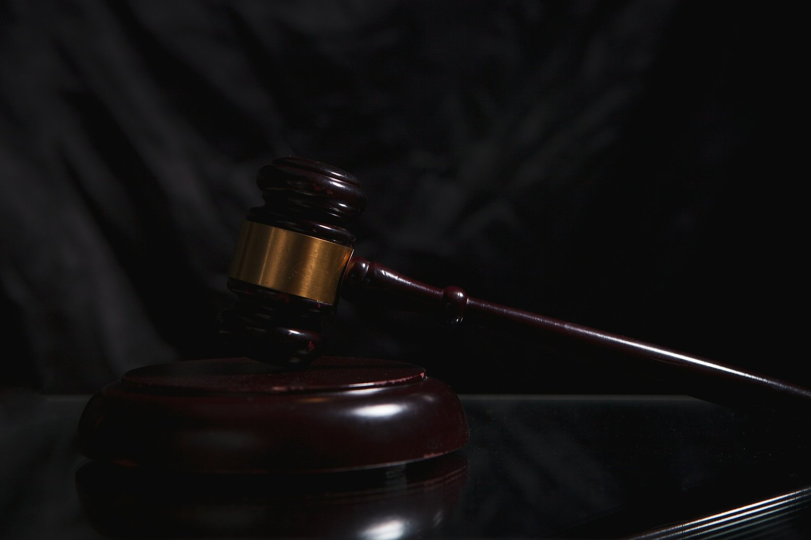 An auctioneer's gavel under a spotlight