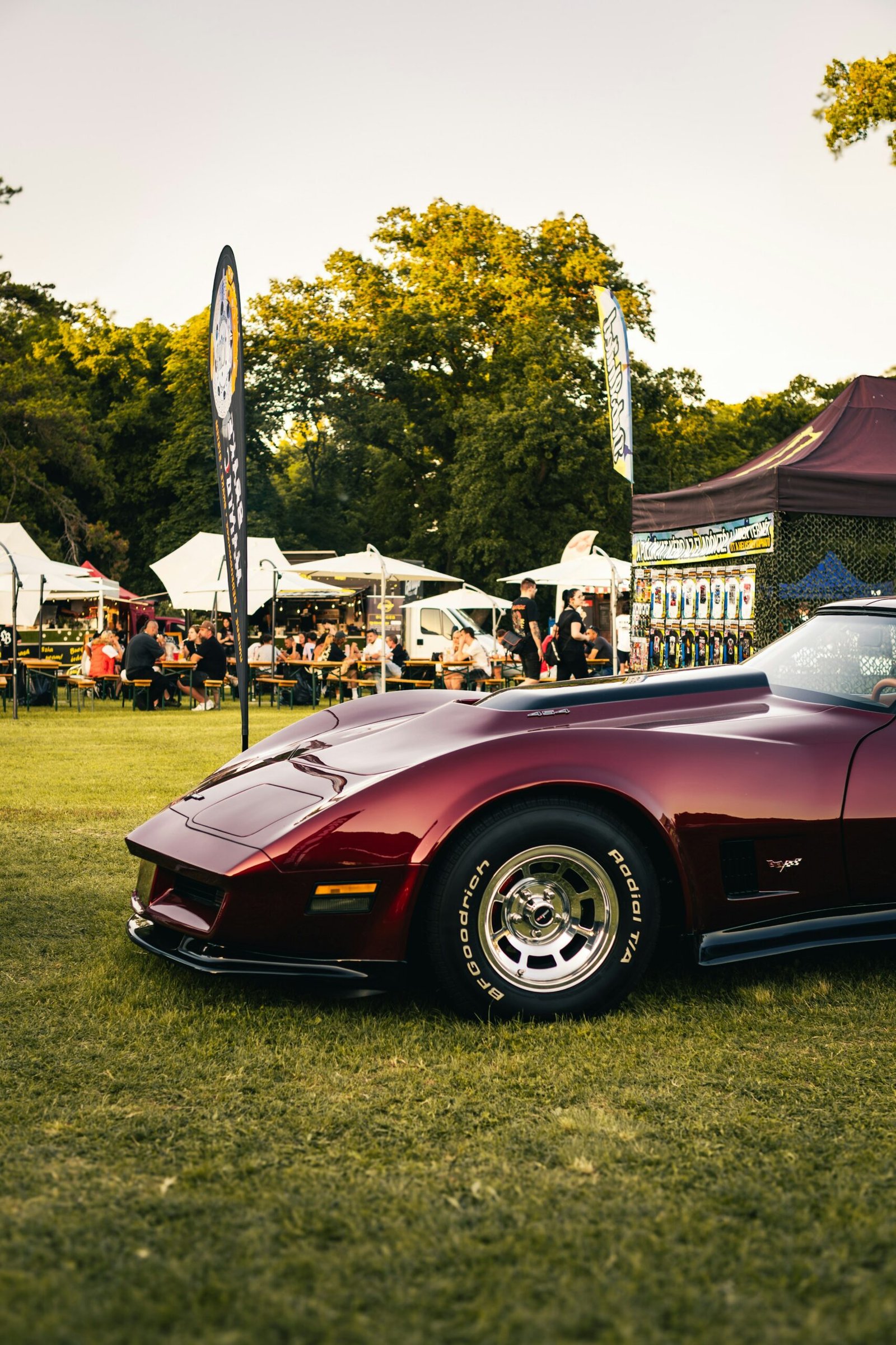 A polished prewar car displayed on a lawn at a classic-car show