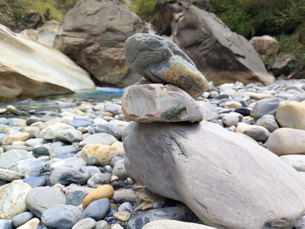 A stack of balanced stones on a riverbank