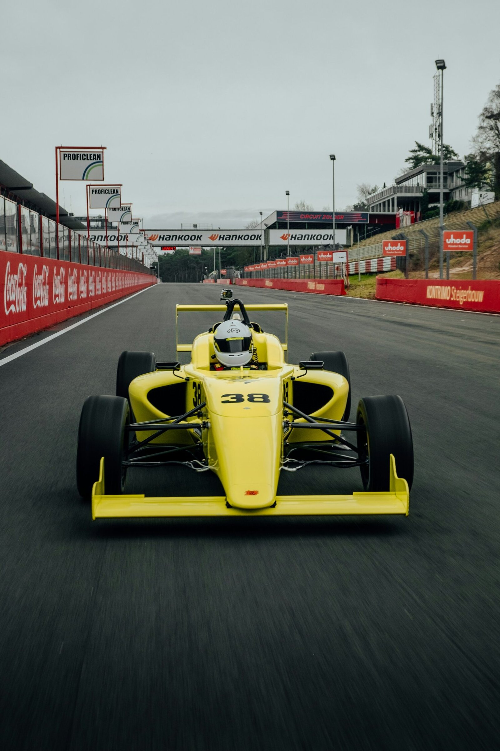 A Formula 1 car at speed on a sunlit circuit