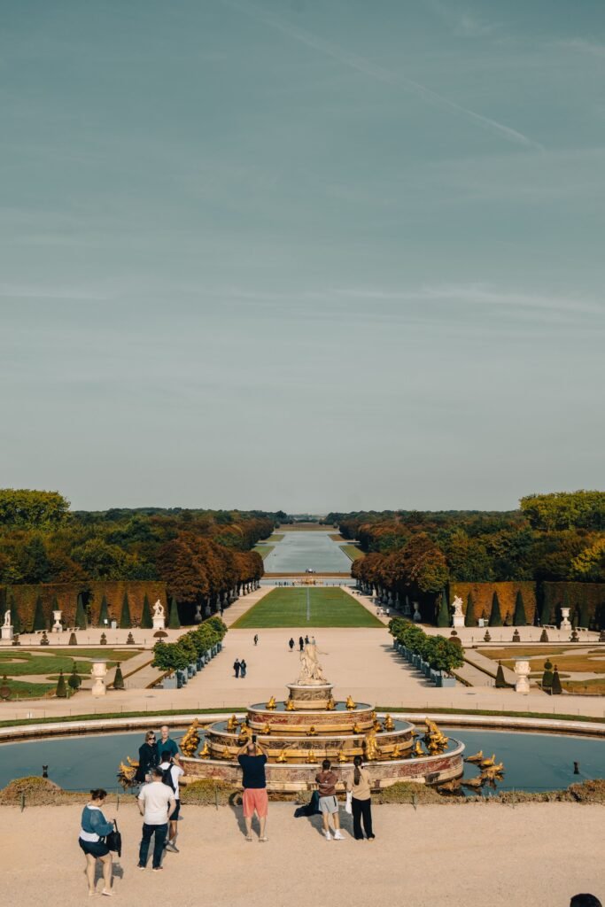 Tree-lined paths in a formal French garden in morning mist