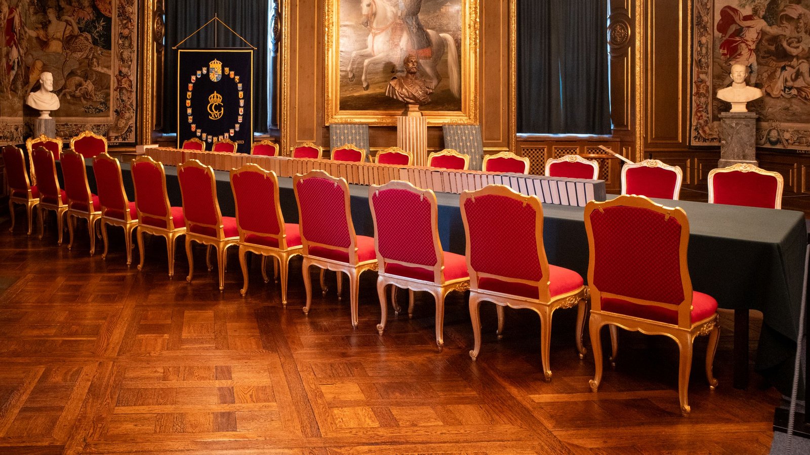 Rows of empty gilded chairs in a grand salon