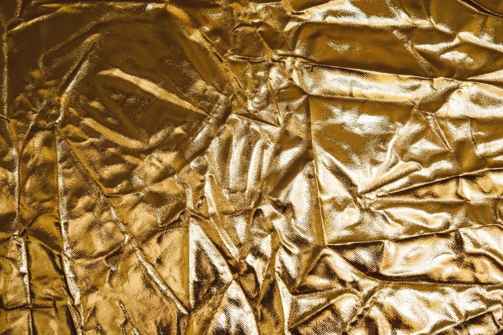 Close-up of gold brocade fabric with a woven pattern