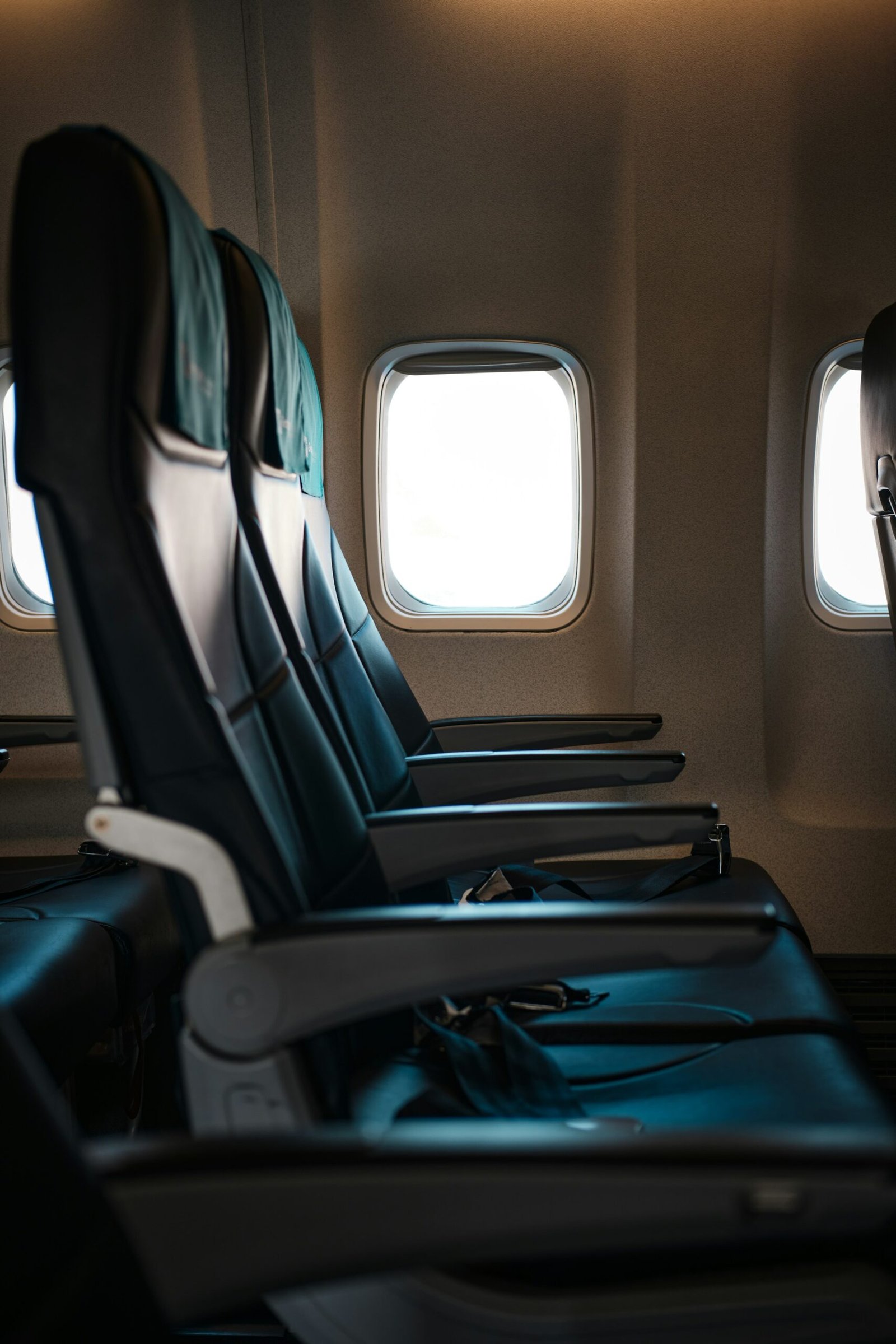 Rows of empty seats either side of the aisle in a widebody aircraft cabin
