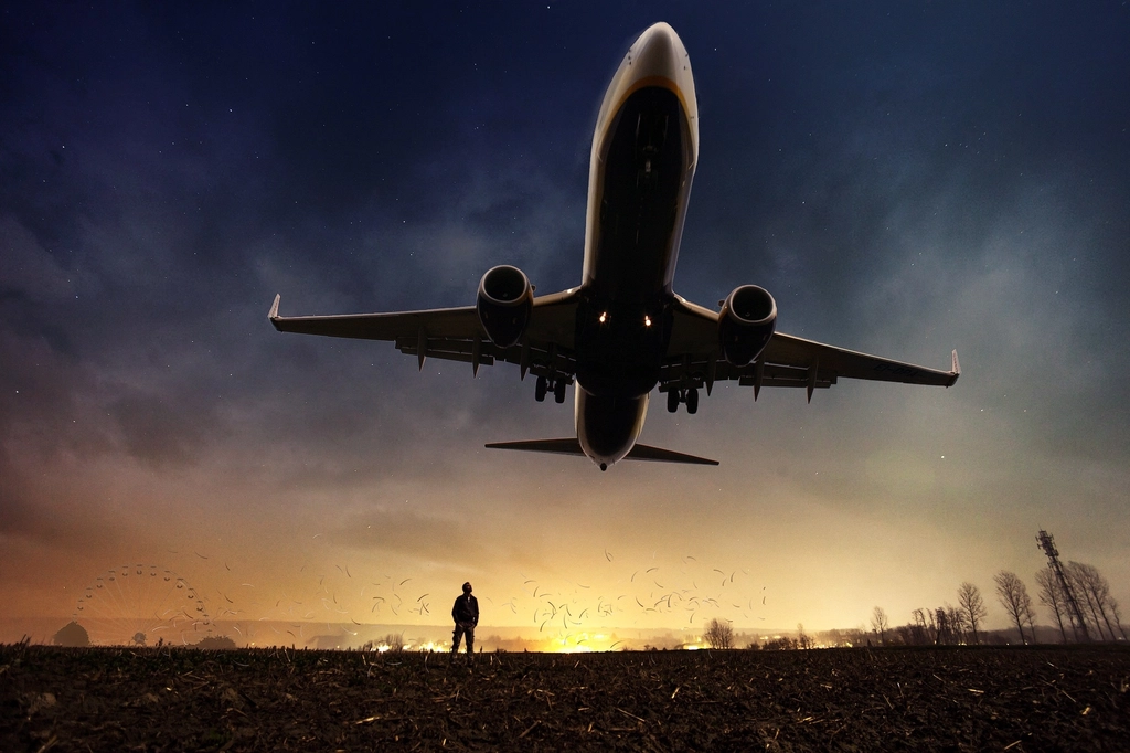 A passenger jet taking off against an evening sky