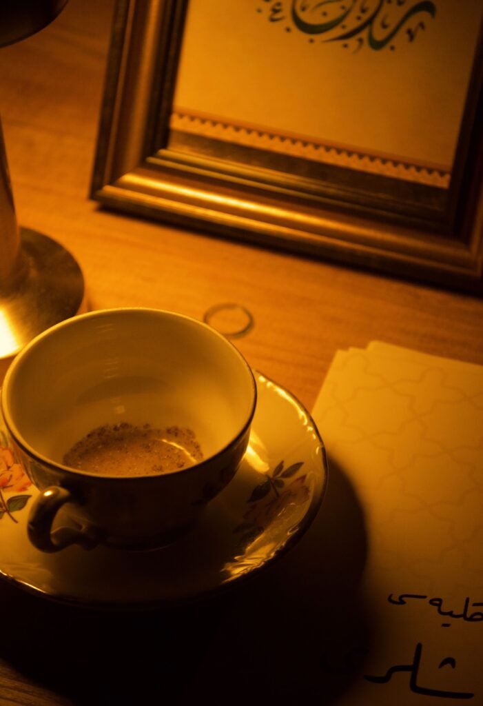 Coffee cups on a candlelit table, with people talking in the background