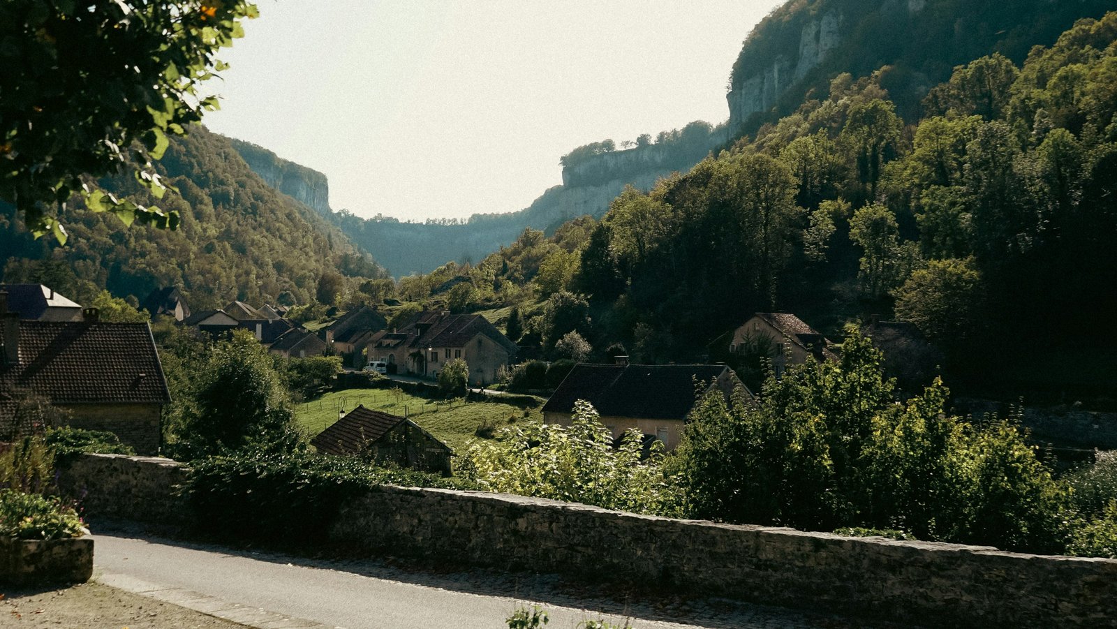 A small town in a green valley of the Swiss Jura in summer
