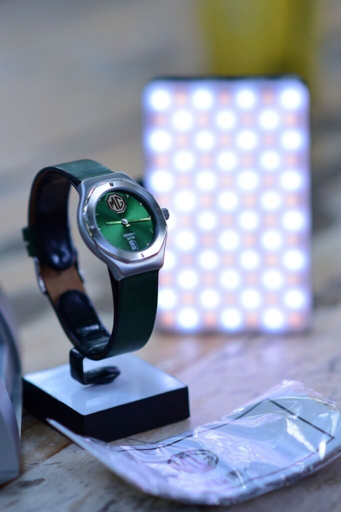 A green-dial watch on a leather strap