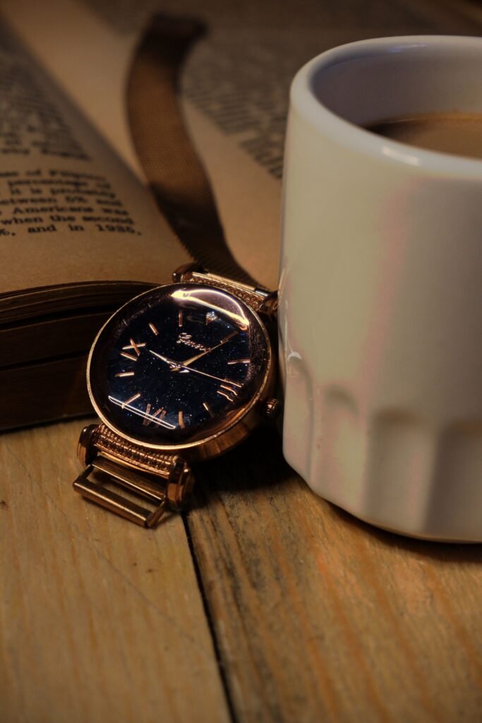 A wristwatch on a wrist resting on a café table