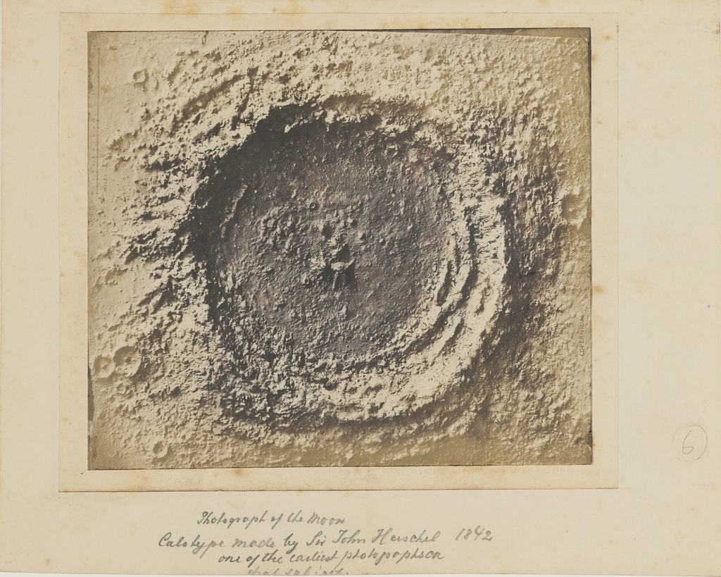 The cratered surface of the moon against a black sky