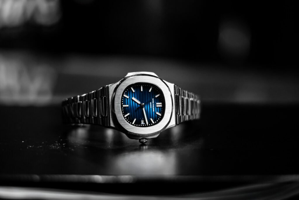 A steel watch with a deep blue dial