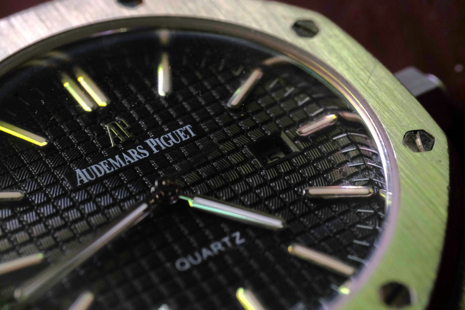 A luxury steel sports watch on its bracelet, photographed on a table