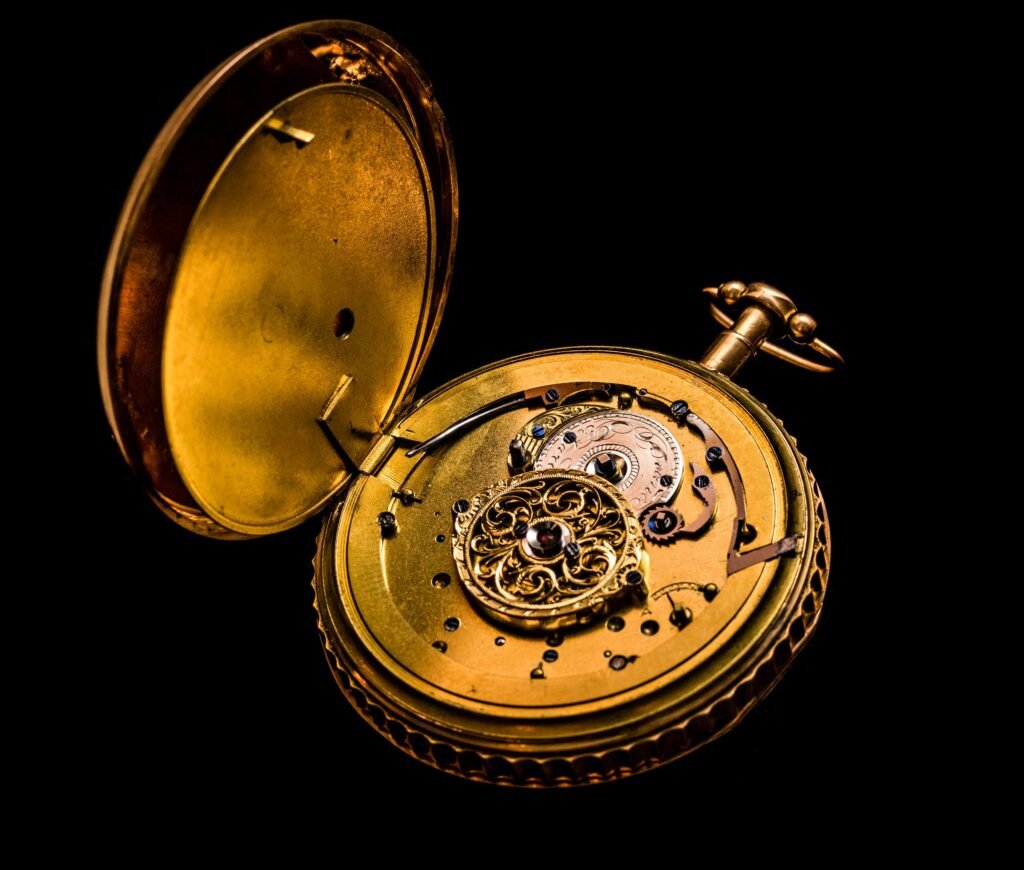 A vintage gold pocket watch showing its mechanism